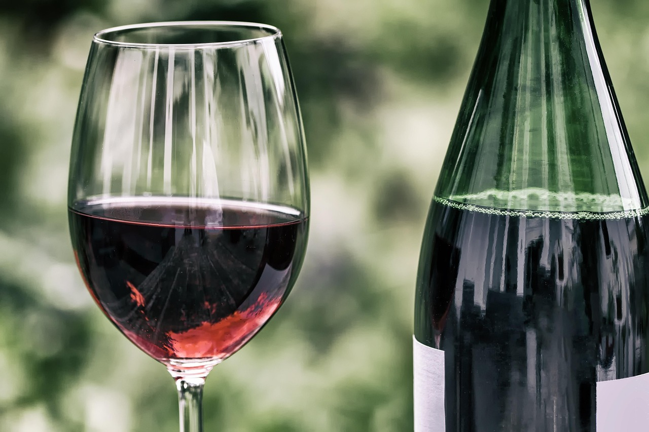 A glass and bottle of red wine