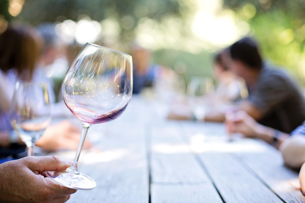 A hand holding a wine glass