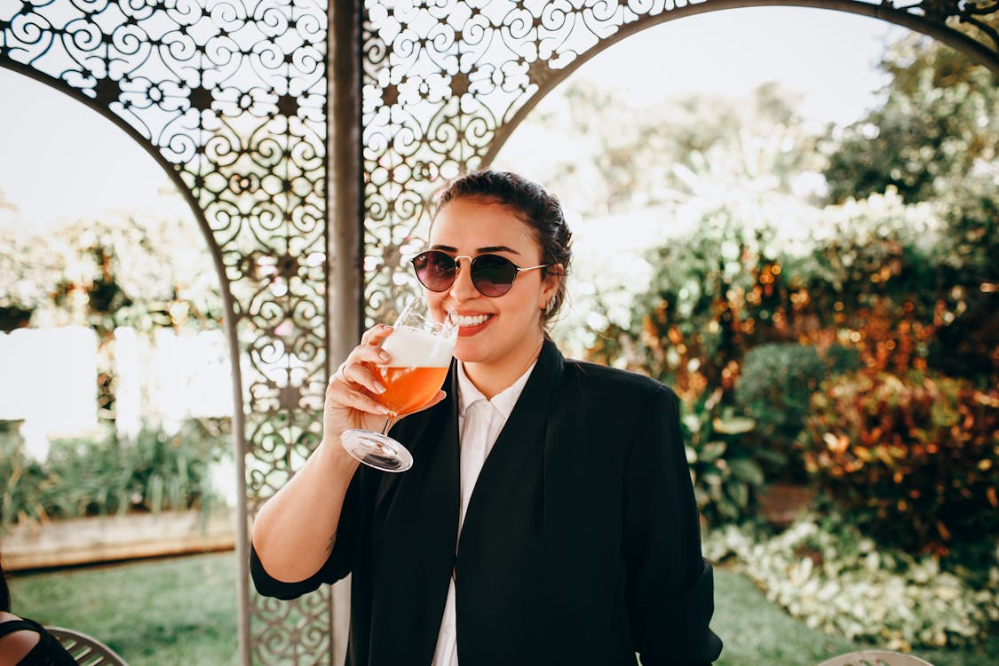A woman with a glass of wine, smiling