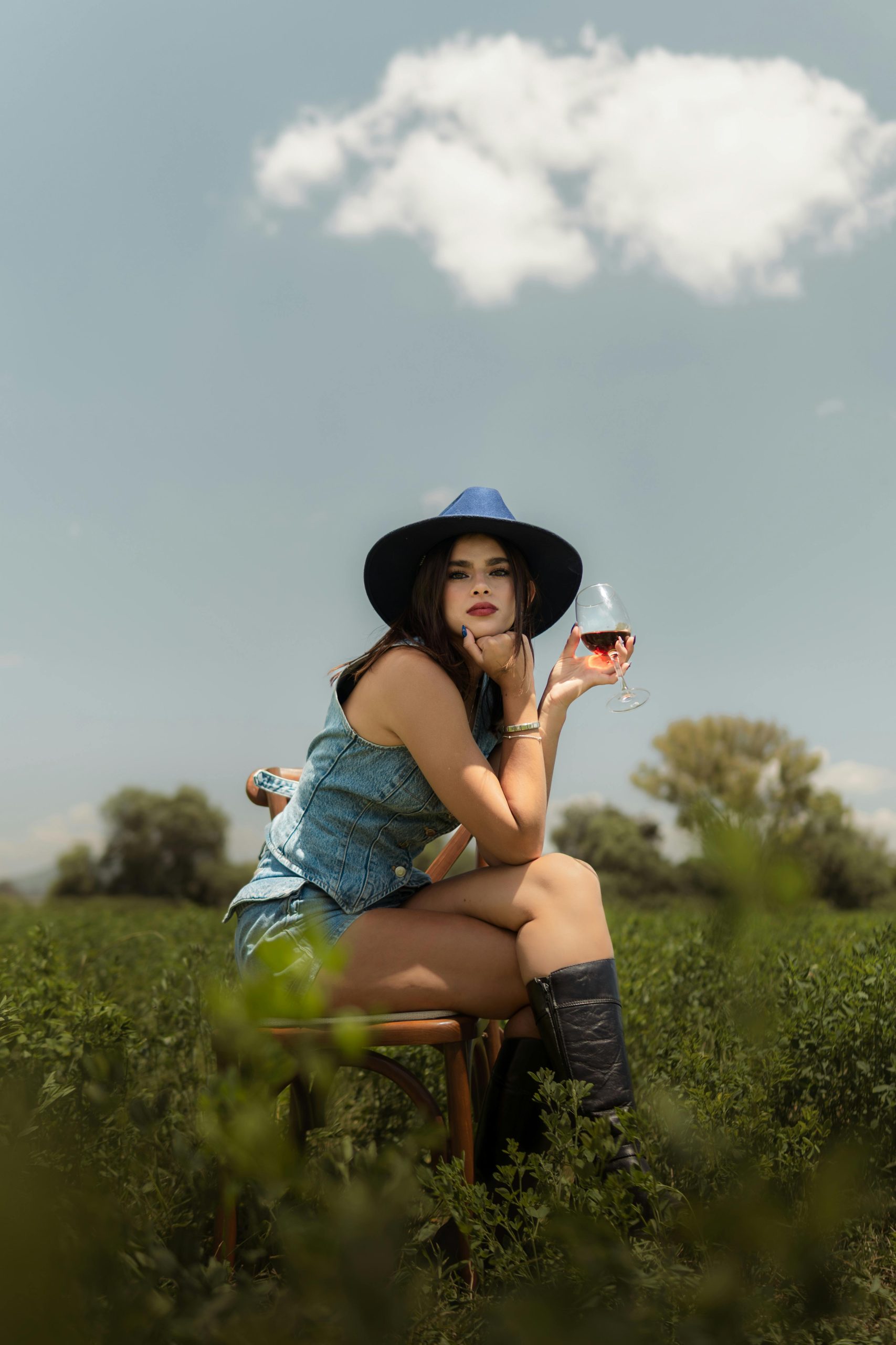 A woman in matching denim attire at a vineyard