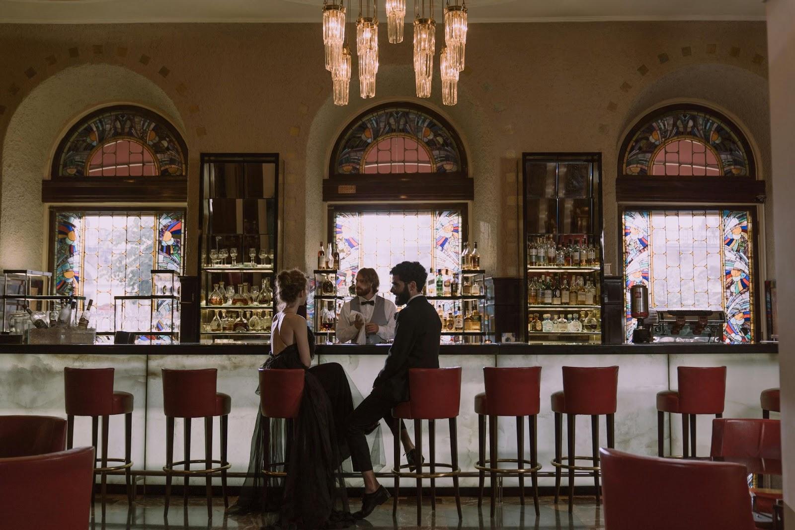 A couple sitting at an elegant bar