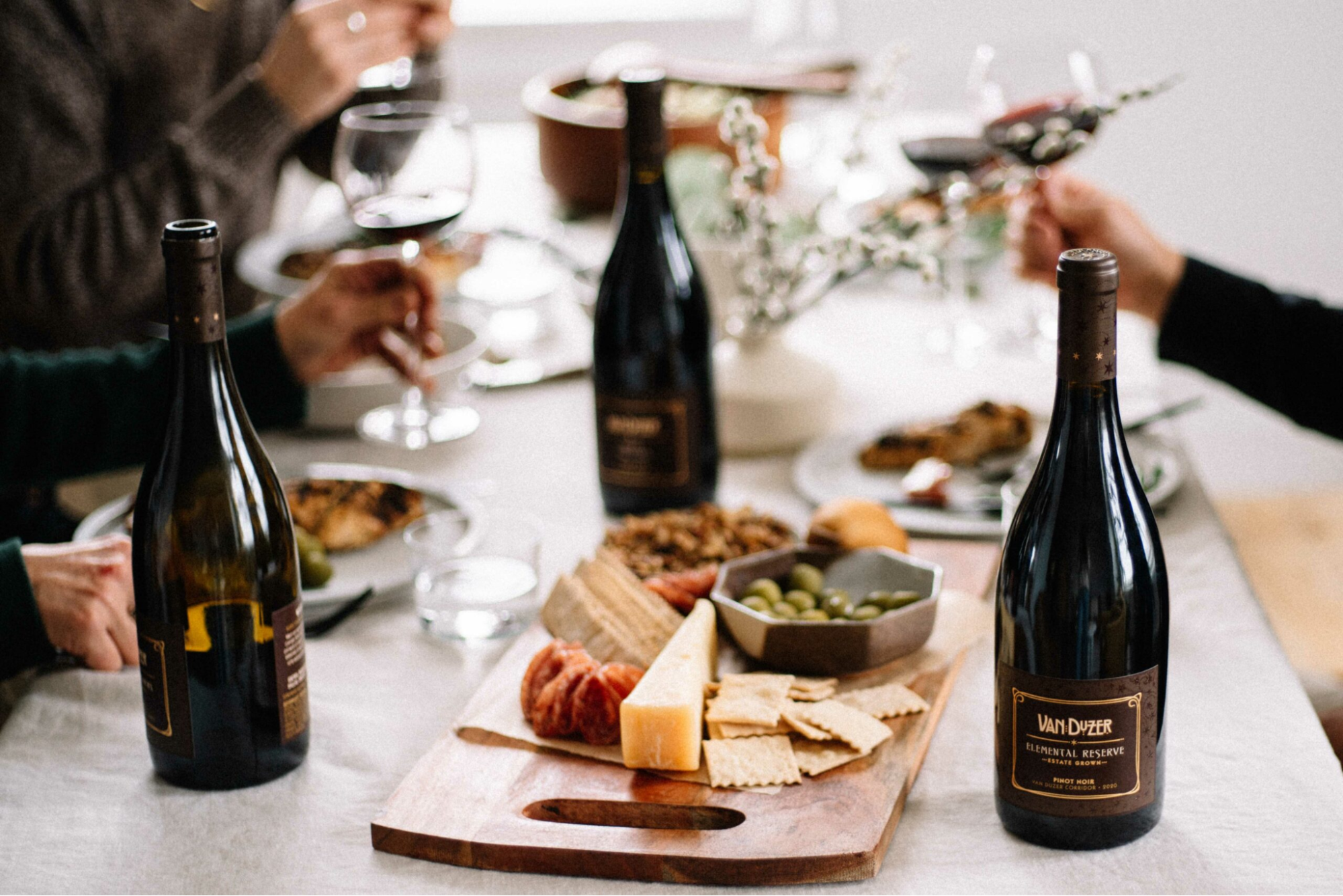 A table with bottles of wine and grazing boards