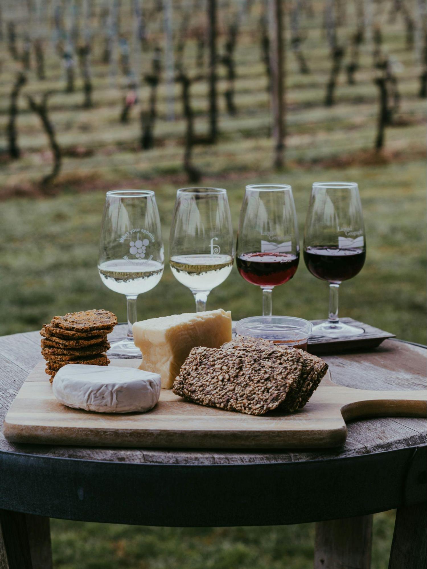 A flight of wine next to a grazing board