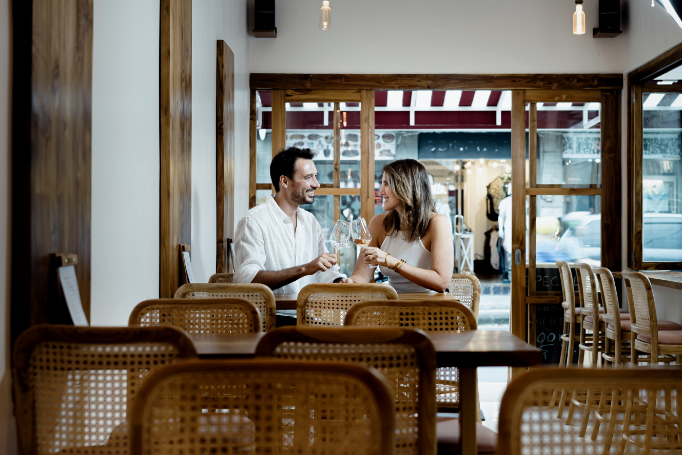 A couple clinking glasses at Belle Wine Bar in Ubud